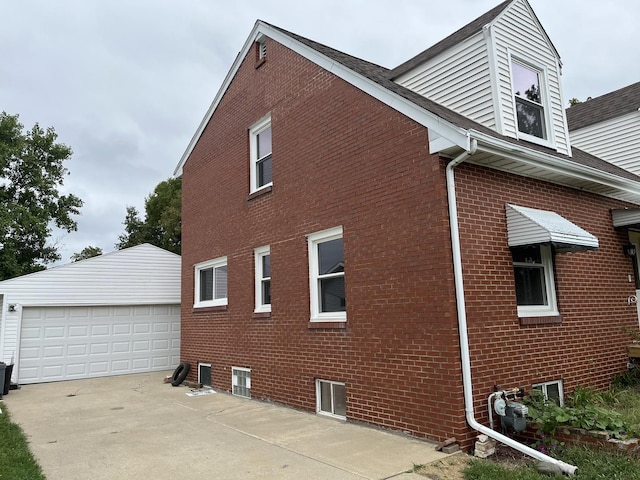 view of side of property with a garage and an outdoor structure