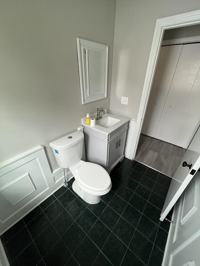 bathroom featuring tile patterned flooring, vanity, and toilet