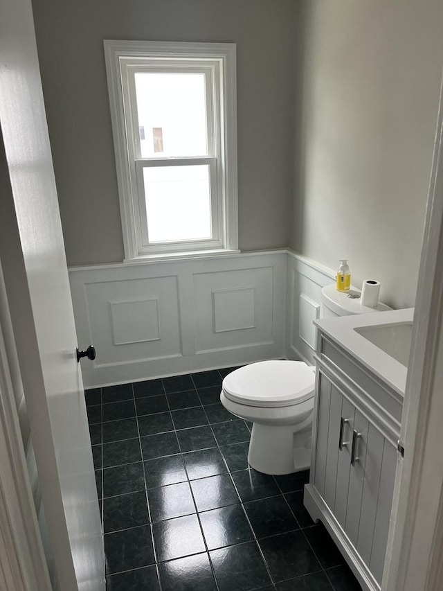 bathroom with vanity, tile patterned floors, and toilet