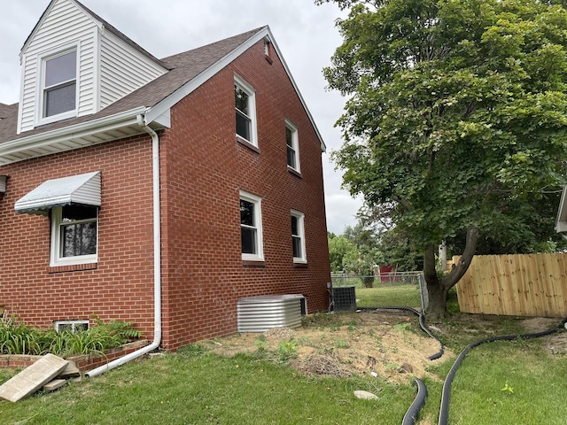 view of side of home featuring a lawn