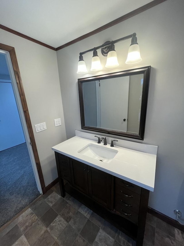 bathroom with crown molding and vanity