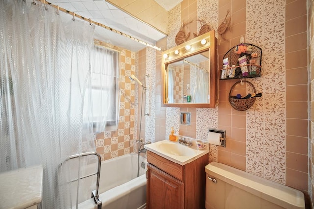 full bathroom featuring toilet, vanity, shower / bath combo, and tile walls