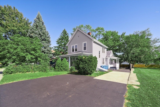 view of side of home with a yard