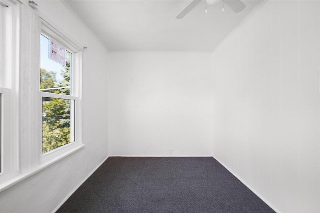 empty room featuring carpet floors, ceiling fan, and ornamental molding