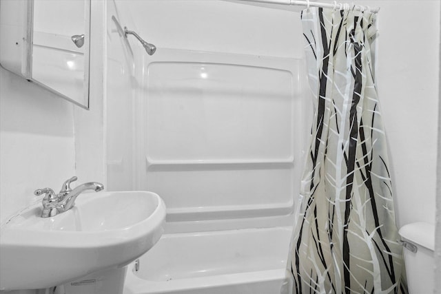 bathroom with shower / bath combo and sink