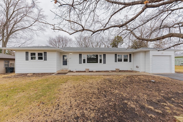 ranch-style home featuring a garage and a front lawn