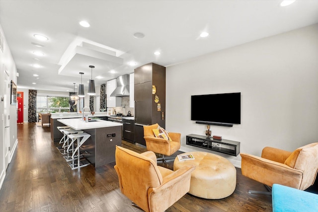 living room with sink and dark hardwood / wood-style floors