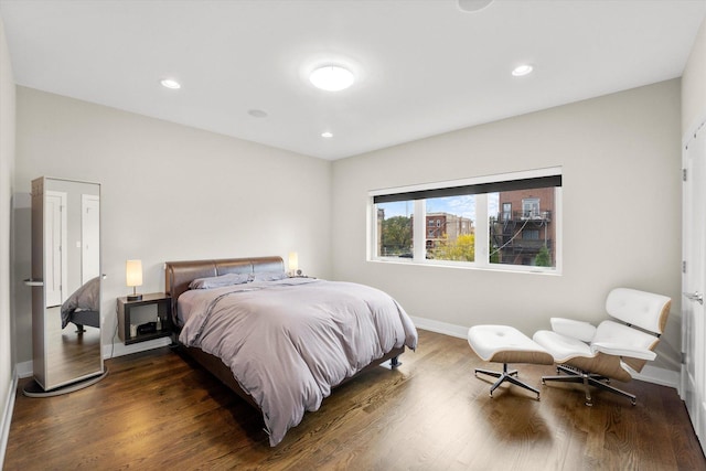 bedroom with dark hardwood / wood-style floors