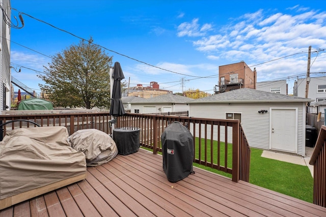 deck featuring a grill and a yard