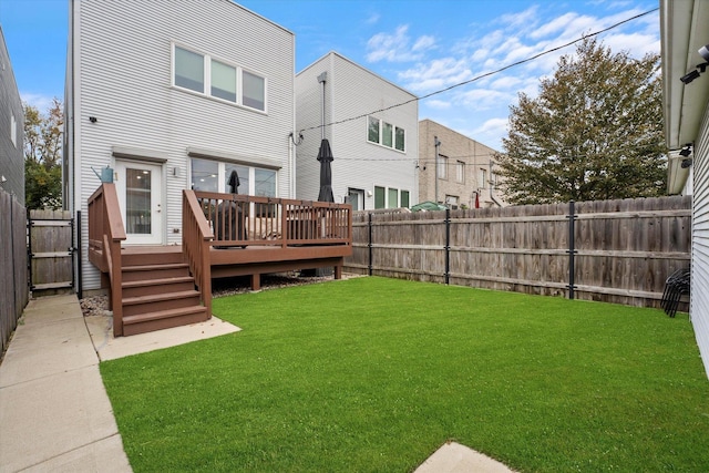 rear view of property featuring a lawn and a deck