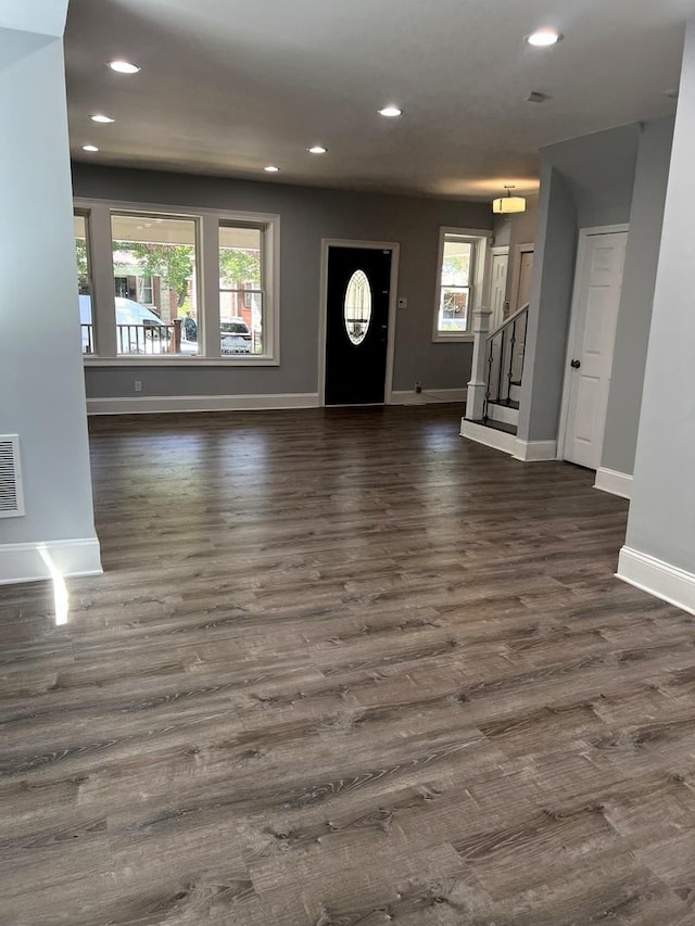 entryway with dark hardwood / wood-style flooring