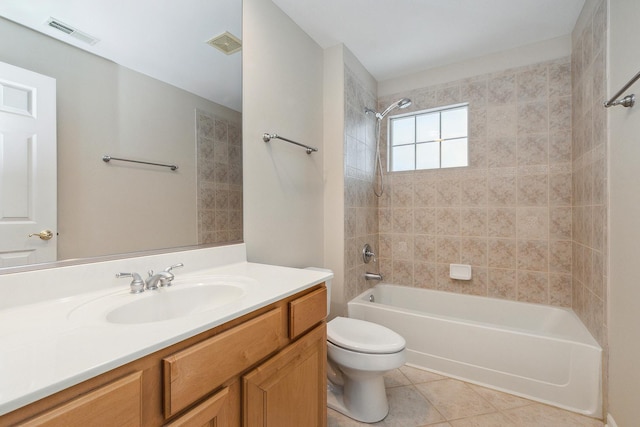 full bathroom with toilet, tiled shower / bath, tile patterned floors, and vanity