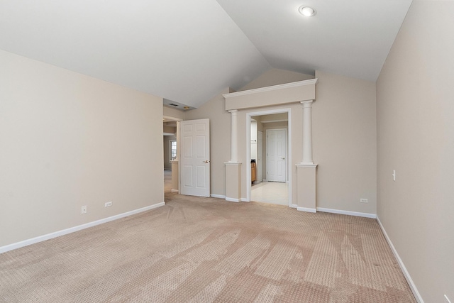 spare room with light carpet and lofted ceiling