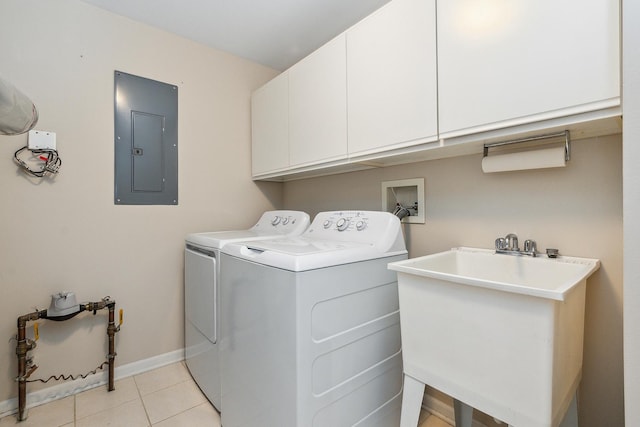 washroom featuring sink, washing machine and clothes dryer, electric panel, cabinets, and light tile patterned flooring