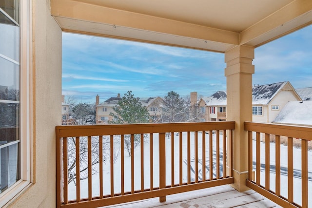 view of snow covered back of property