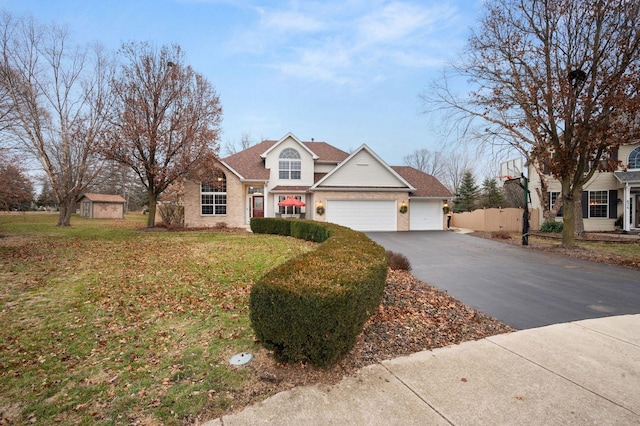 view of front of home with a garage and a front yard