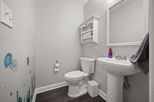 bathroom with hardwood / wood-style floors and toilet