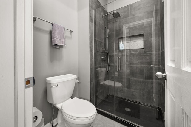 bathroom with toilet, tile patterned floors, and walk in shower