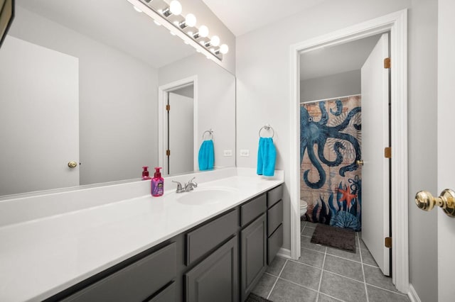 bathroom featuring vanity, tile patterned flooring, and toilet