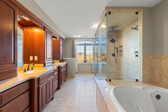 bathroom featuring plus walk in shower, tile patterned floors, and vanity