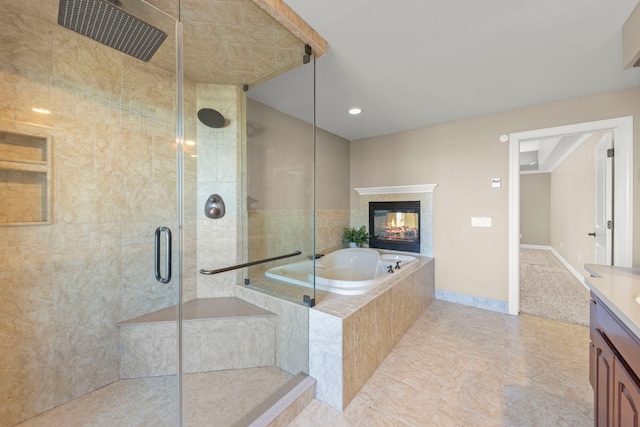 bathroom with vanity, tile patterned flooring, and shower with separate bathtub