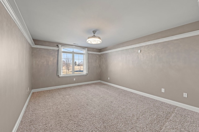 carpeted spare room featuring crown molding