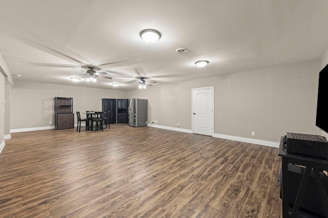 living room with ceiling fan and dark hardwood / wood-style floors