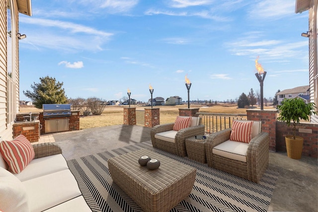 view of patio / terrace with exterior kitchen and a grill