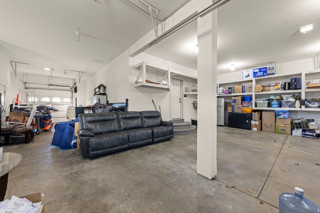 garage with stainless steel refrigerator