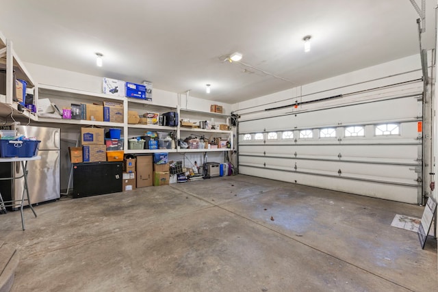 garage with stainless steel fridge