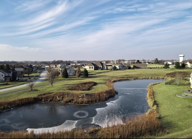 view of home's community featuring a water view and a lawn