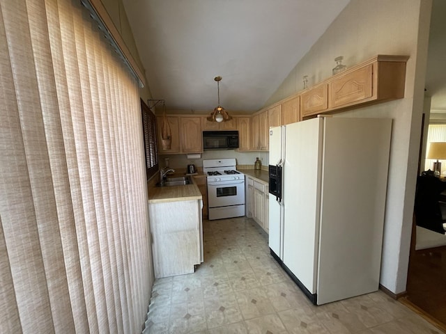 kitchen with white appliances, lofted ceiling, light brown cabinetry, hanging light fixtures, and sink