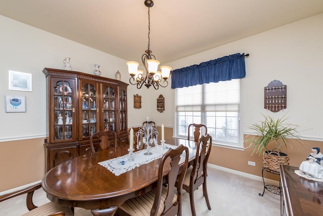 carpeted dining space featuring a notable chandelier