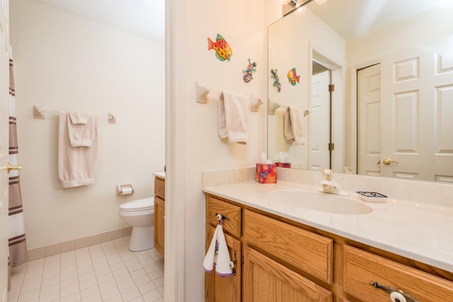 bathroom featuring vanity, toilet, and tile patterned floors