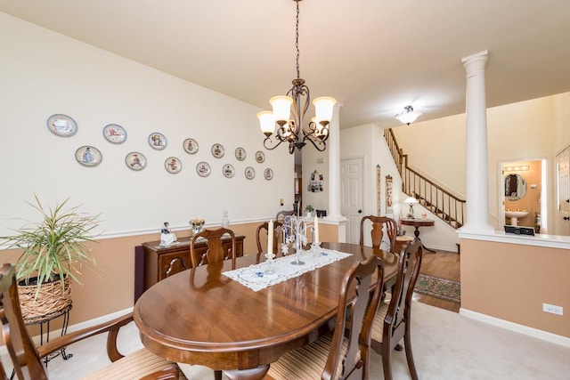 dining area with decorative columns and an inviting chandelier