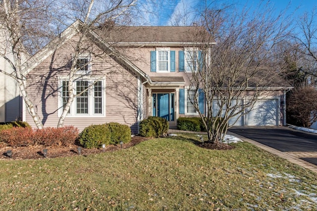 front of property featuring a garage and a front lawn