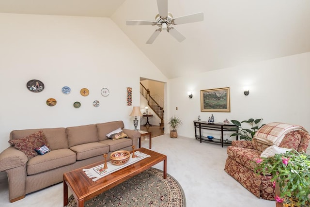 living room featuring ceiling fan, high vaulted ceiling, and light colored carpet