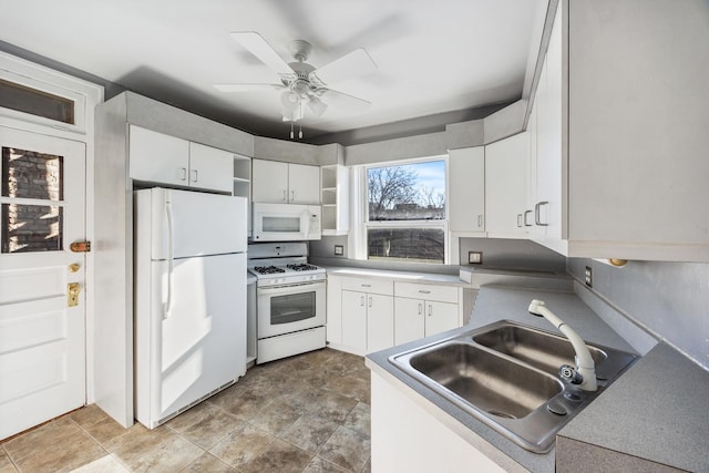 kitchen with ceiling fan, sink, white appliances, and white cabinets