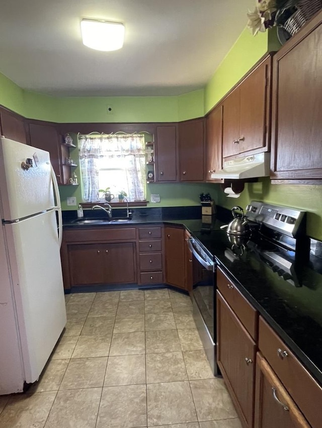 kitchen with light tile patterned flooring, sink, white fridge, and electric stove