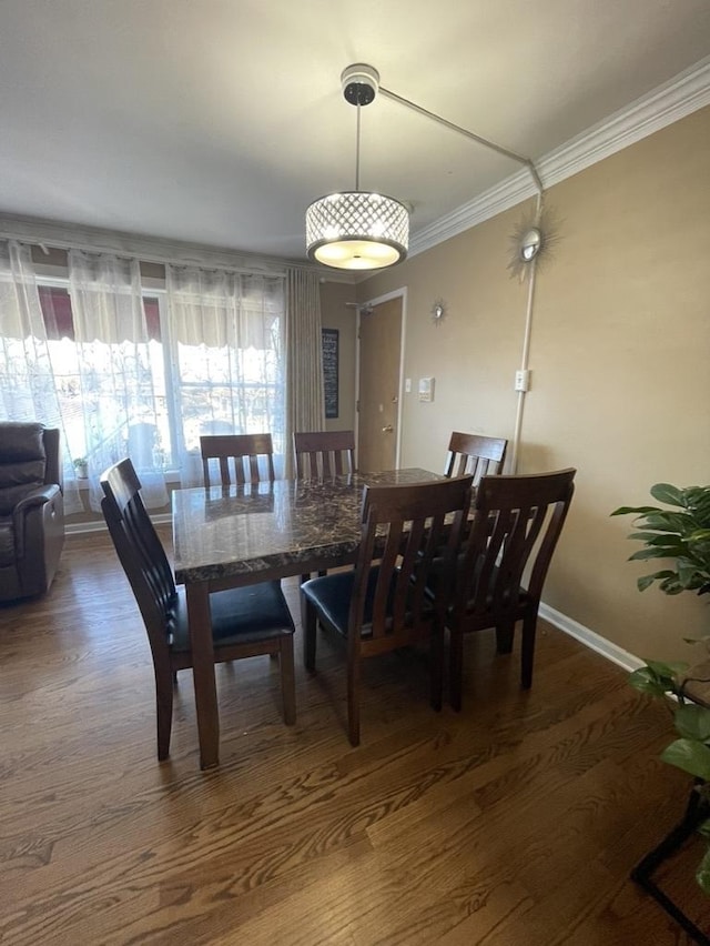 dining space featuring crown molding and wood-type flooring