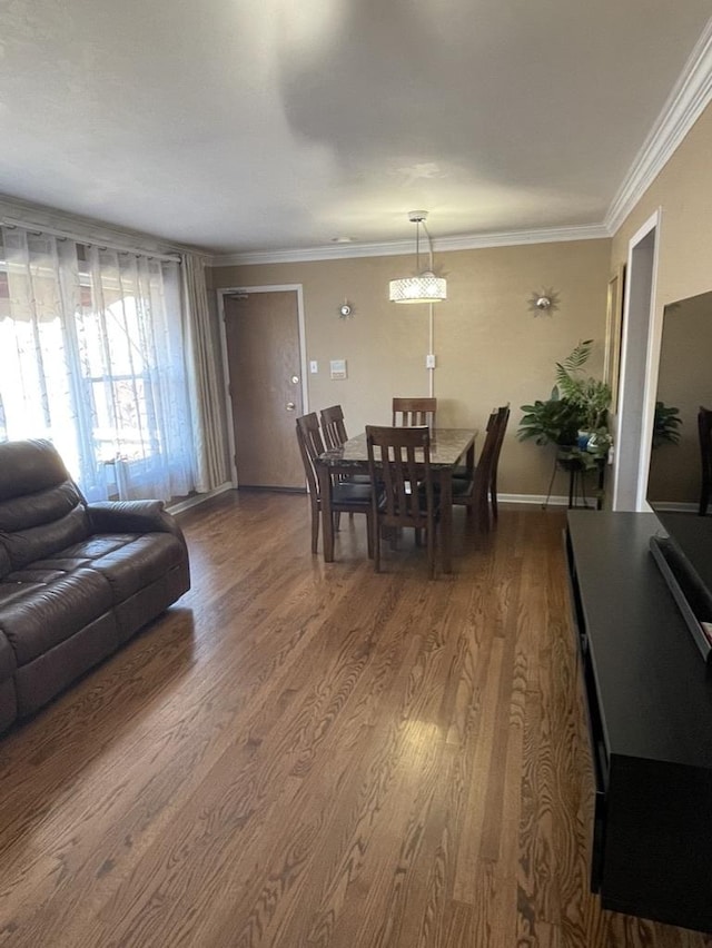 dining area with crown molding and hardwood / wood-style flooring