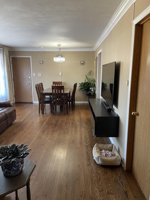 living room with hardwood / wood-style floors and ornamental molding