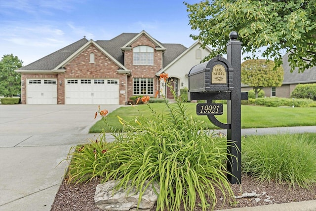 view of front facade featuring a front lawn and a garage