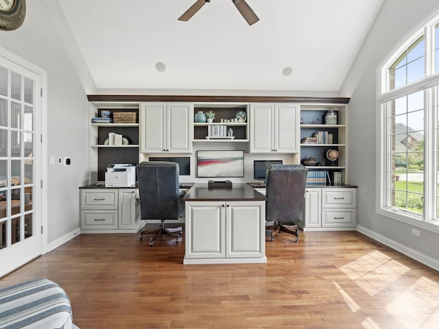 office featuring ceiling fan, lofted ceiling, and light wood-type flooring