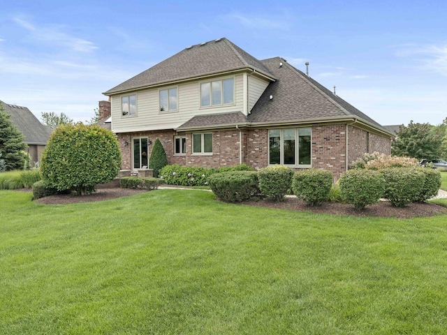 back of house featuring a lawn