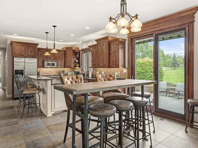 dining space with a chandelier and sink