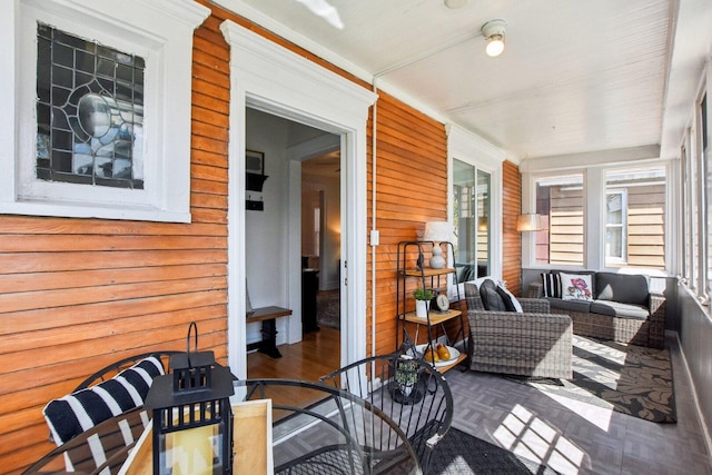 sunroom / solarium with an outdoor hangout area and outdoor dining space