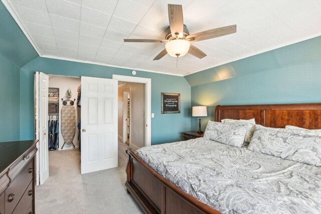 bedroom featuring light carpet, crown molding, and ceiling fan