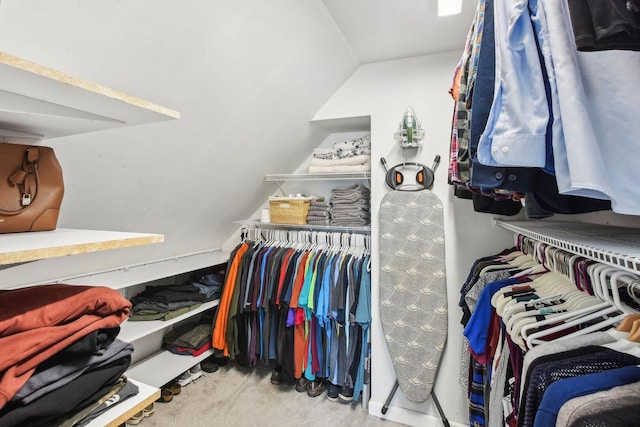 walk in closet with lofted ceiling and carpet floors