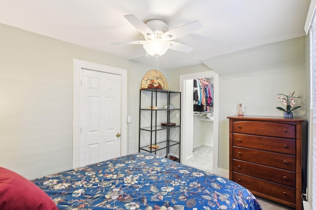 bedroom featuring carpet flooring, baseboards, a spacious closet, a closet, and ceiling fan